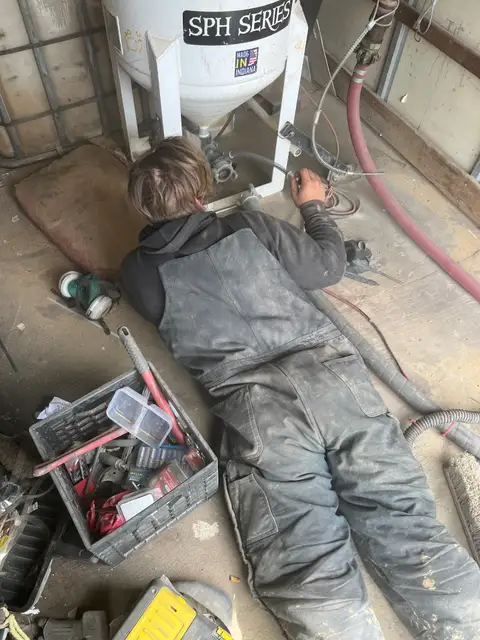 Hands-on and focused, tackling the task at hand.